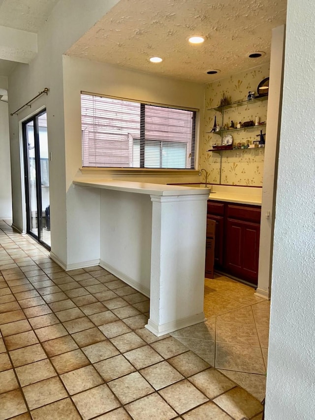 1903 Barons Gln, Sugar Land, TX 77478 - kitchen with light countertops, light tile patterned floors, recessed lighting, a peninsula, and baseboards