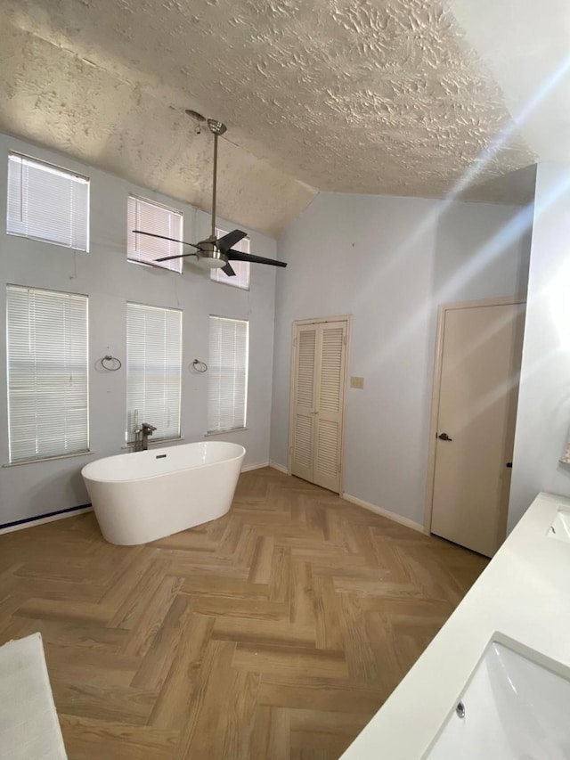 1903 Barons Gln, Sugar Land, TX 77478 - full bath featuring lofted ceiling, a soaking tub, a ceiling fan, baseboards, and double vanity