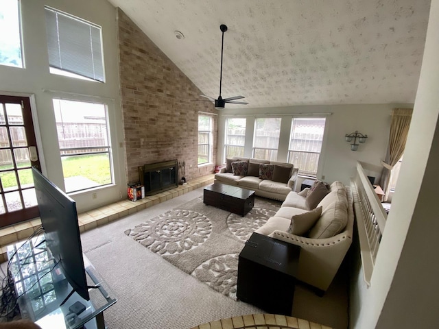 1903 Barons Gln, Sugar Land, TX 77478 - carpeted living room featuring high vaulted ceiling, healthy amount of natural light, a ceiling fan, and a fireplace