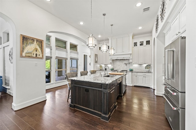 5518 Fleming Rock Ln, Fulshear, TX 77441 - kitchen with appliances with stainless steel finishes, a sink, white cabinetry, a center island with sink, and dark wood finished floors
