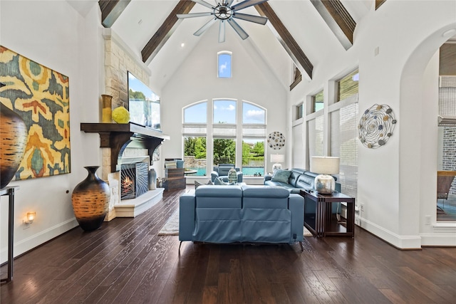 5518 Fleming Rock Ln, Fulshear, TX 77441 - living room with high vaulted ceiling, a ceiling fan, arched walkways, beamed ceiling, and a stone fireplace