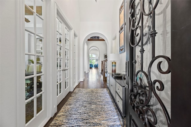 5518 Fleming Rock Ln, Fulshear, TX 77441 - hall featuring french doors, arched walkways, and dark wood finished floors