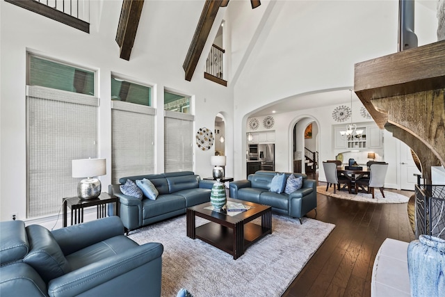 5518 Fleming Rock Ln, Fulshear, TX 77441 - living area with arched walkways, a chandelier, dark wood-style flooring, a high ceiling, and beam ceiling