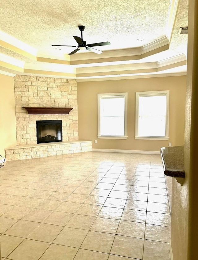 1207 S Diamondhead Blvd, Crosby, TX 77532 - unfurnished living room with ornamental molding, a raised ceiling, a textured ceiling, a ceiling fan, and a fireplace
