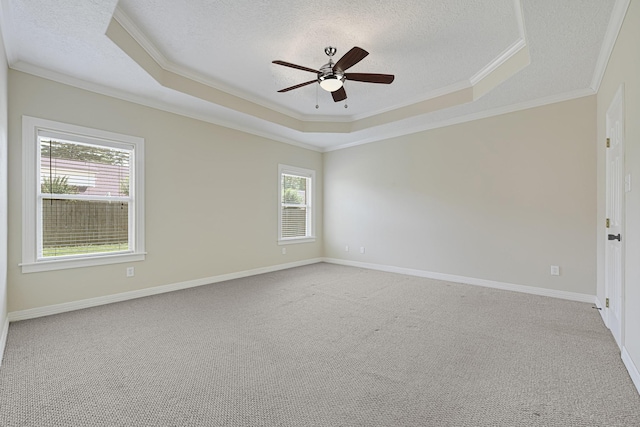 1207 S Diamondhead Blvd, Crosby, TX 77532 - spare room featuring a raised ceiling, a textured ceiling, crown molding, ceiling fan, and light colored carpet