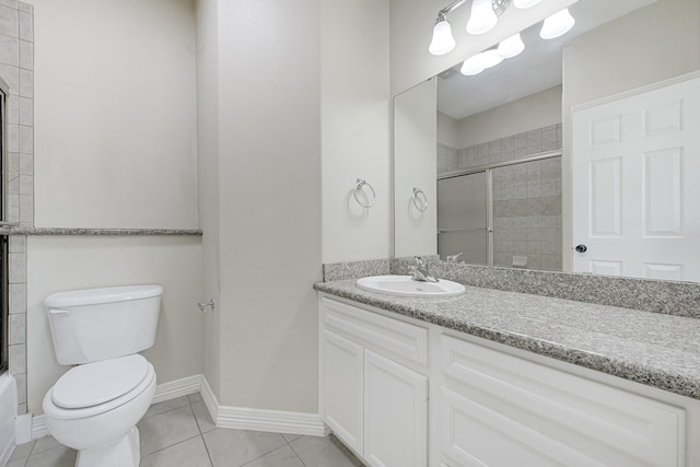 1207 S Diamondhead Blvd, Crosby, TX 77532 - full bathroom with vanity, a tile shower, toilet, tile patterned flooring, and baseboards