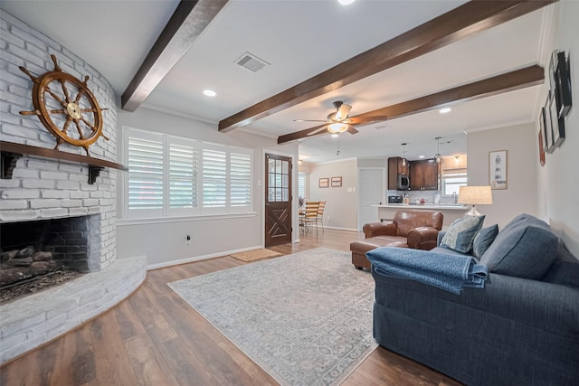 living area featuring beam ceiling, wood finished floors, ceiling fan, baseboards, and recessed lighting