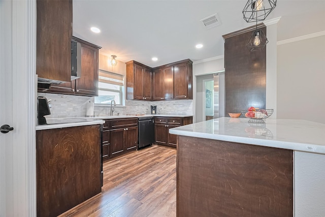 kitchen featuring black dishwasher, crown molding, light wood-type flooring, dark brown cabinetry, and light countertops