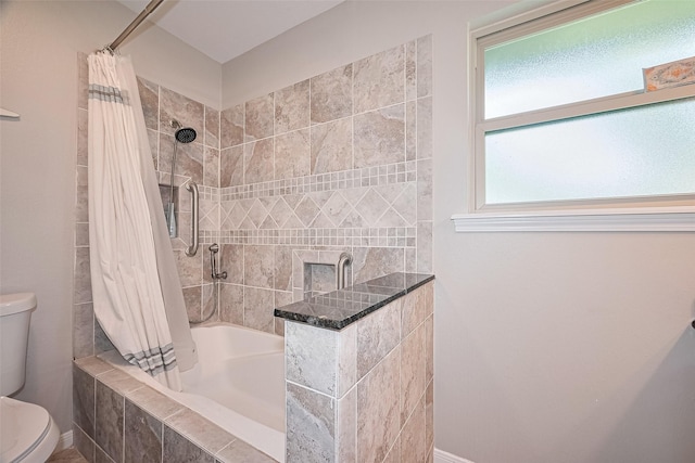 full bathroom featuring toilet and tiled shower / bath combo