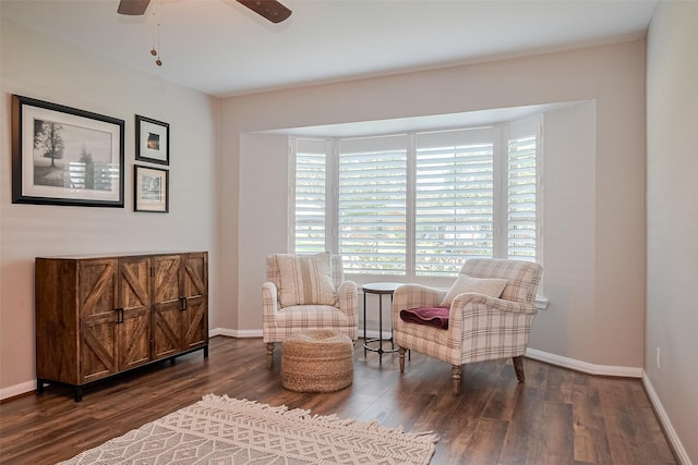 living area featuring wood finished floors, a ceiling fan, and baseboards