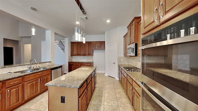 11111 Monte Rosa Ct, Richmond, TX 77406 - kitchen with a sink, stainless steel appliances, brown cabinets, tasteful backsplash, and recessed lighting