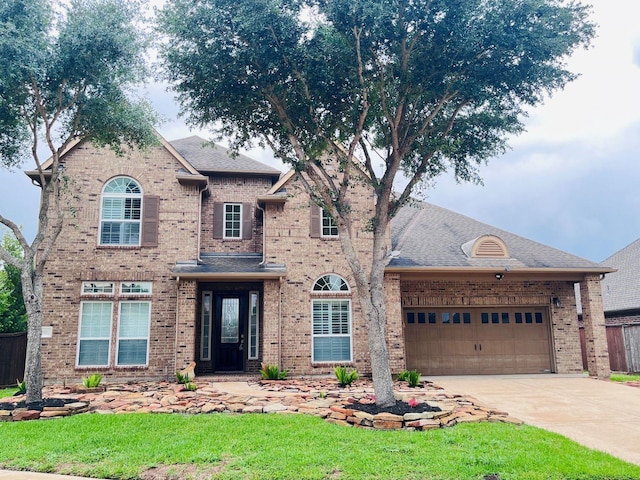 11111 Monte Rosa Ct, Richmond, TX 77406 - traditional home featuring brick siding, an attached garage, concrete driveway, and roof with shingles
