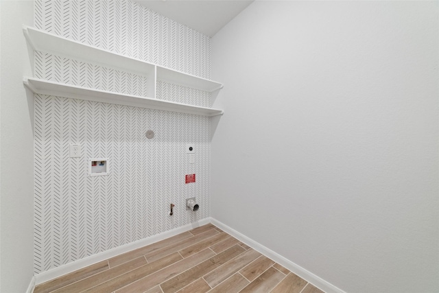 19806 Lone Paddock Cir, Tomball, TX 77377 - laundry room with hookup for a gas dryer, electric dryer hookup, light wood-style floors, baseboards, and hookup for a washing machine