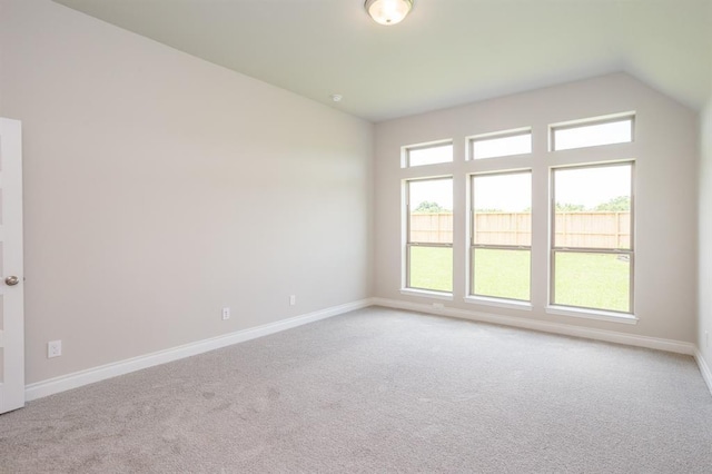 1639 Rosedale Dr, Missouri City, TX 77459 - spare room featuring light carpet, baseboards, and vaulted ceiling