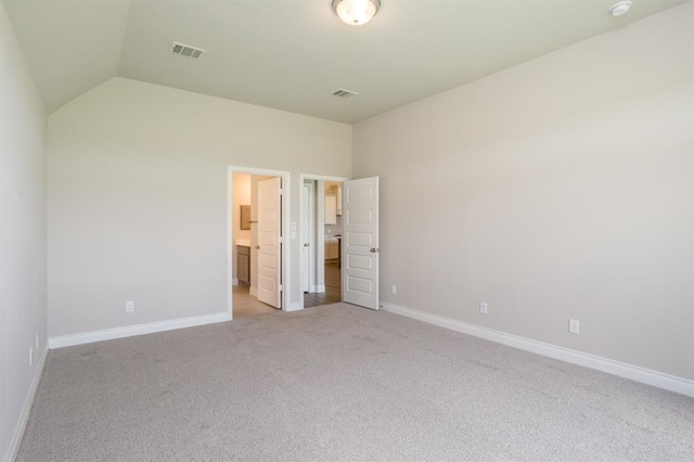 1639 Rosedale Dr, Missouri City, TX 77459 - unfurnished bedroom with light colored carpet, baseboards, lofted ceiling, and ensuite bathroom