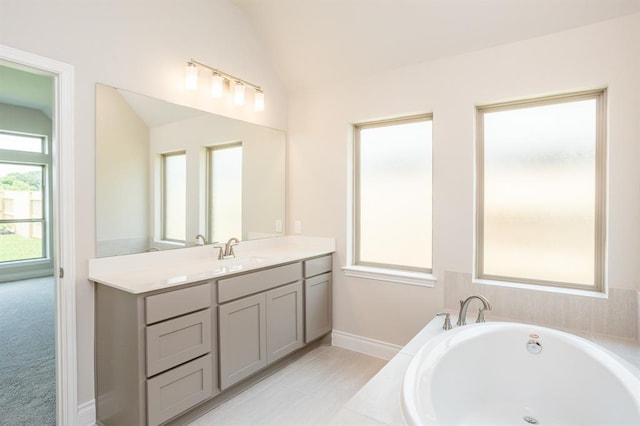 1639 Rosedale Dr, Missouri City, TX 77459 - full bath with a garden tub, vanity, lofted ceiling, and baseboards
