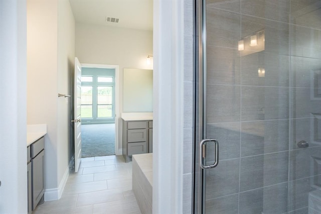 1639 Rosedale Dr, Missouri City, TX 77459 - full bathroom with vanity, a shower stall, tile patterned flooring, and baseboards