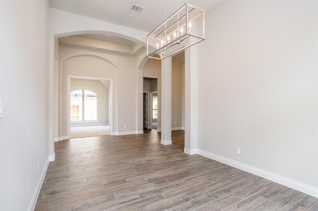 1639 Rosedale Dr, Missouri City, TX 77459 - empty room featuring arched walkways, wood finished floors, and baseboards