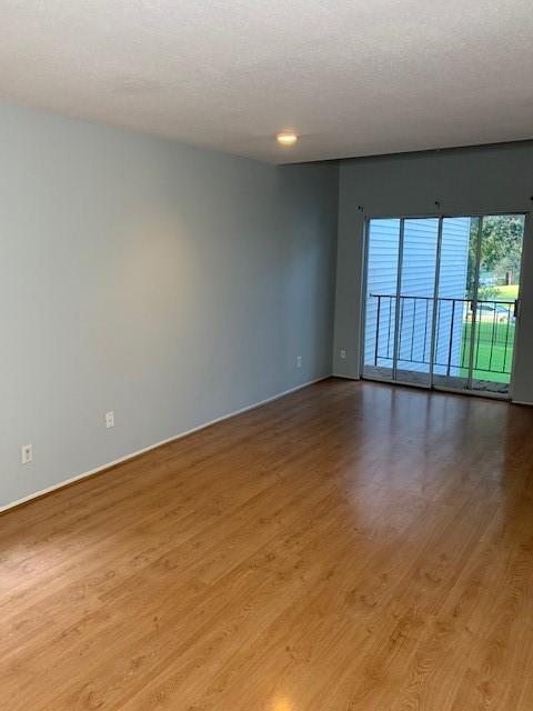 empty room with wood finished floors and baseboards