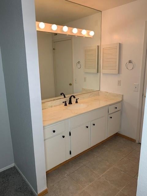 bathroom with vanity and baseboards