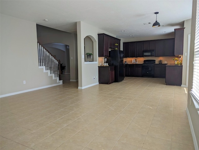10718 Wall Fern Way, Houston, TX 77034 - kitchen with black appliances, open floor plan, arched walkways, light tile patterned floors, and baseboards