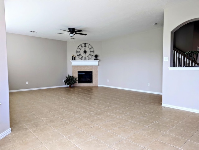 10718 Wall Fern Way, Houston, TX 77034 - unfurnished living room with ceiling fan, light tile patterned floors, baseboards, and a fireplace