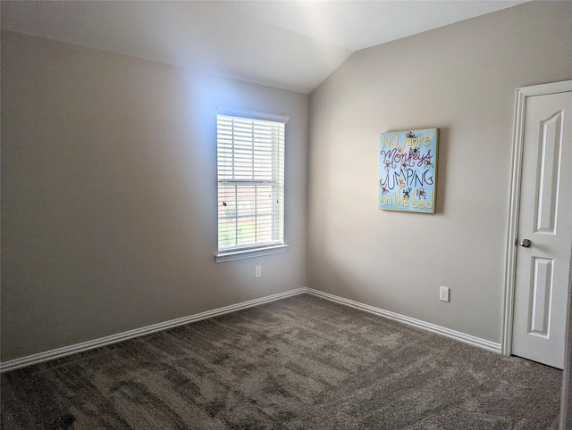 10718 Wall Fern Way, Houston, TX 77034 - empty room featuring dark carpet, lofted ceiling, and baseboards