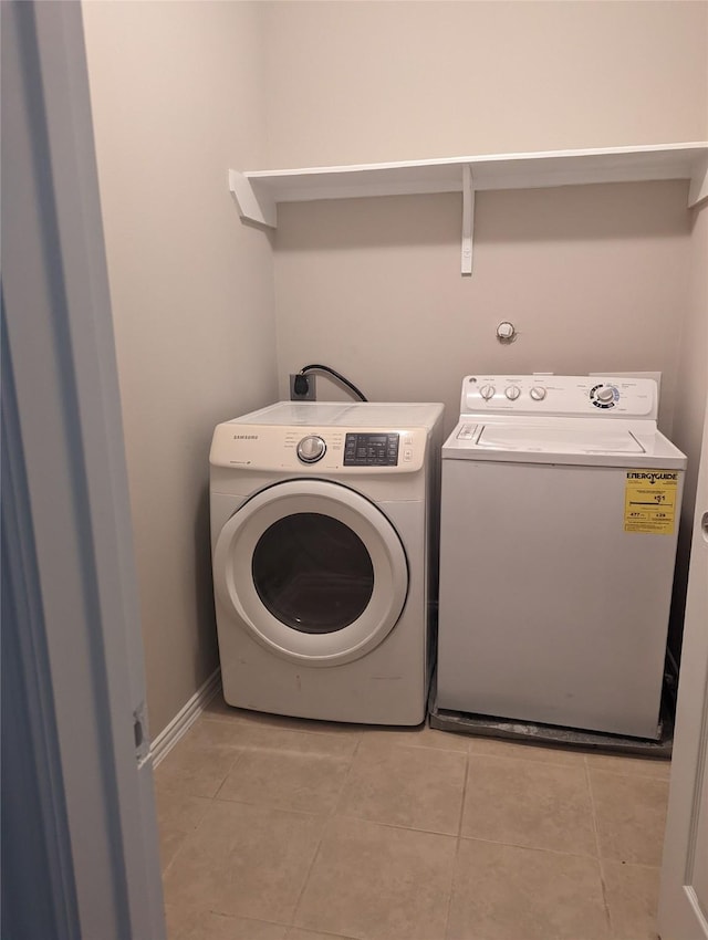 10718 Wall Fern Way, Houston, TX 77034 - clothes washing area featuring light tile patterned floors and independent washer and dryer
