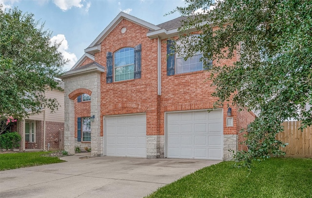 traditional-style home with concrete driveway, stone siding, a garage, fence, and brick siding