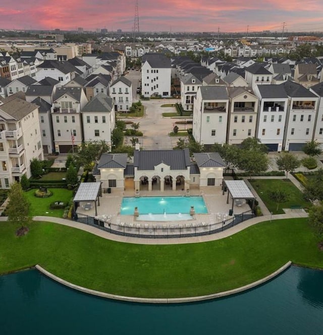 3507 Eaton Estates Ln, Houston, TX 77055 - aerial view at dusk of view of pool, a water view, and a residential view