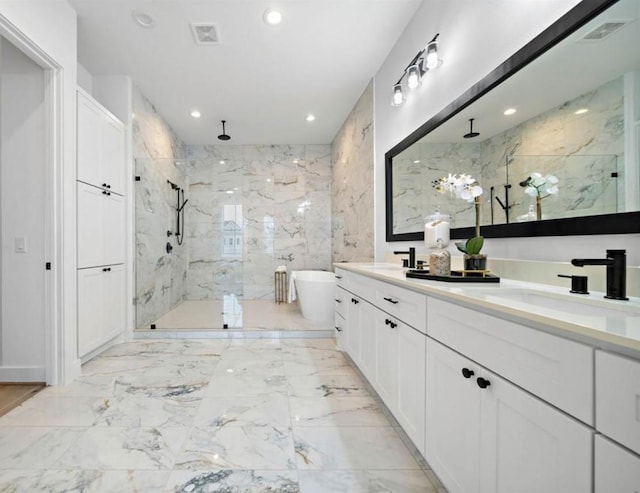 3507 Eaton Estates Ln, Houston, TX 77055 - bathroom featuring a marble finish shower, recessed lighting, a soaking tub, marble finish floors, and double vanity