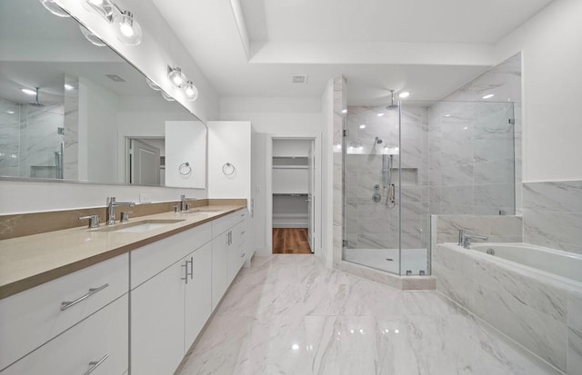 3507 Eaton Estates Ln, Houston, TX 77055 - bathroom featuring a marble finish shower, a bath, double vanity, marble look tile flooring, and a spacious closet
