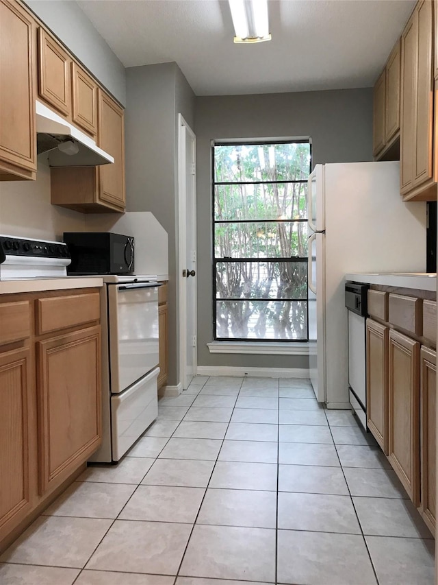 kitchen featuring under cabinet range hood, white appliances, light countertops, and light tile patterned floors