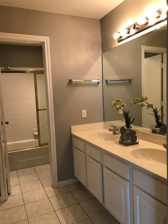 bathroom with tile patterned flooring, double vanity, and shower / bathtub combination