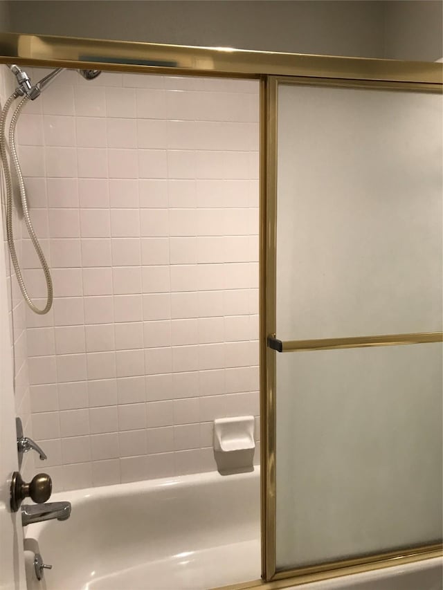 full bathroom with bath / shower combo with glass door