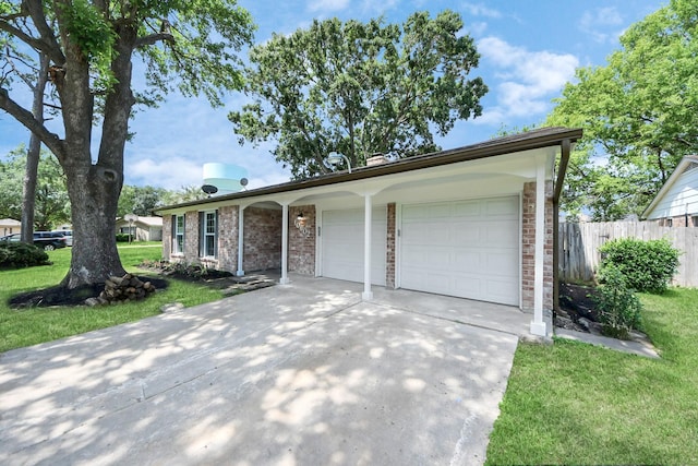 ranch-style home featuring driveway, brick siding, and an attached garage