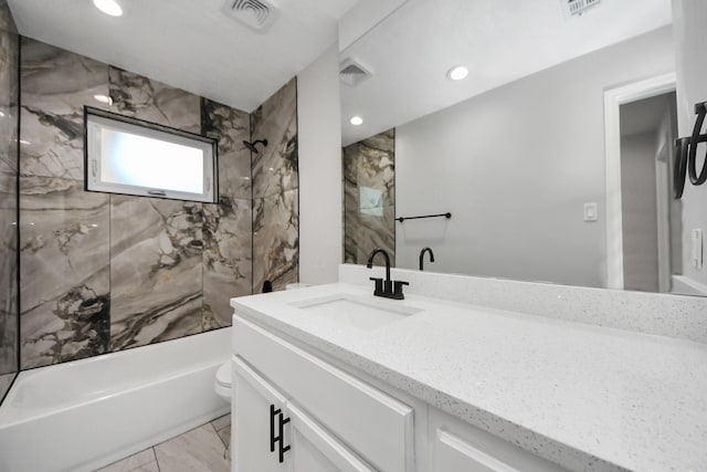 bathroom with marble finish floors, vanity, recessed lighting, and bathtub / shower combination