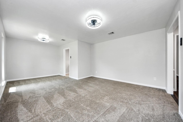 empty room with carpet and baseboards