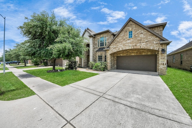 view of front facade featuring driveway, a front lawn, brick siding, and an attached garage