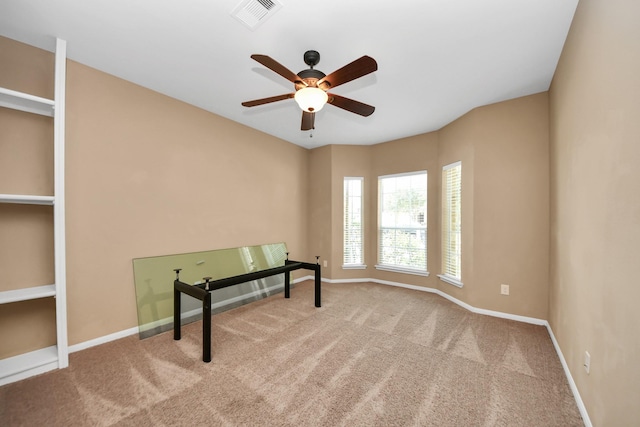 empty room featuring a ceiling fan, carpet floors, and baseboards