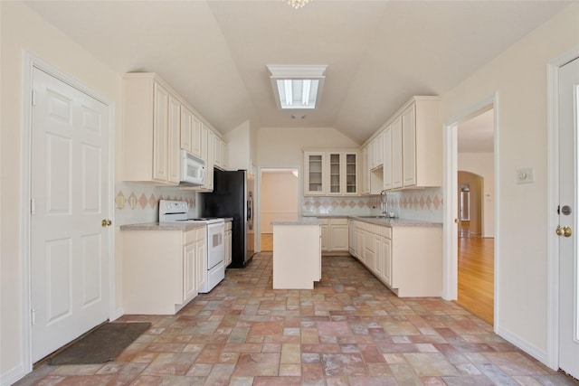 18415 Deer Crossing Dr, Humble, TX 77346 - kitchen featuring white appliances, backsplash, arched walkways, a sink, and light countertops