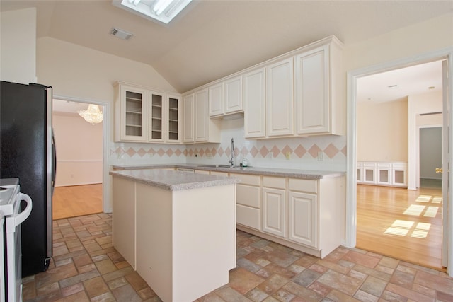18415 Deer Crossing Dr, Humble, TX 77346 - kitchen featuring a sink, white range with electric cooktop, light countertops, decorative backsplash, and vaulted ceiling