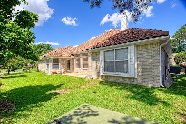 18415 Deer Crossing Dr, Humble, TX 77346 - rear view of property featuring a tiled roof, a chimney, central air condition unit, and a patio