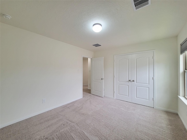 4015 Mossy Banks Ln, Houston, TX 77068 - unfurnished bedroom with carpet floors, baseboards, a closet, and a textured ceiling