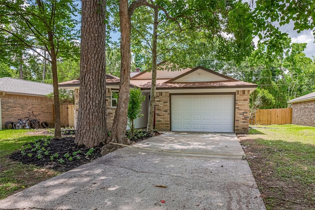 23331 Balthasar St, Spring, TX 77373 - view of front of property with brick siding, driveway, and a garage