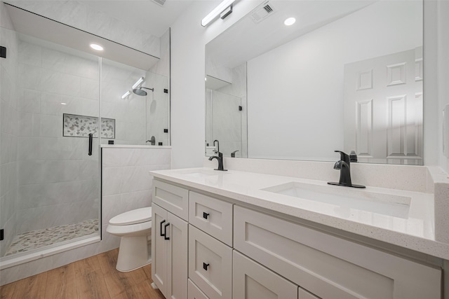 23331 Balthasar St, Spring, TX 77373 - full bath with toilet, a stall shower, wood finished floors, and double vanity