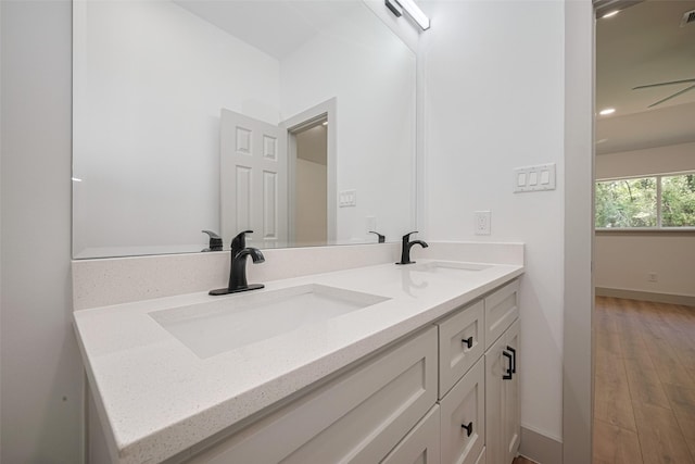 23331 Balthasar St, Spring, TX 77373 - full bathroom with double vanity, wood finished floors, and baseboards