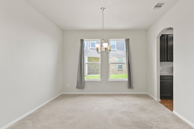 3011 Tandem Ct, Rosenberg, TX 77471 - unfurnished dining area featuring light carpet, a chandelier, baseboards, and arched walkways