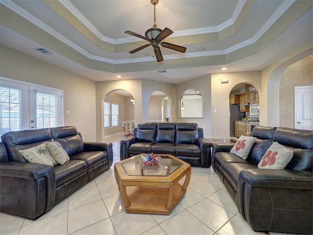 15614 Escapade St, Corpus Christi, TX 78418 - living area with a raised ceiling, arched walkways, a ceiling fan, light tile patterned floors, and crown molding