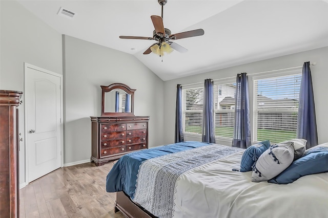 bedroom with wood finished floors, vaulted ceiling, and a ceiling fan